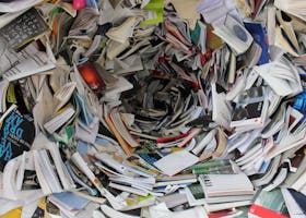 A whirlwind of books and papers creating a chaotic visual. Ideal for concepts of disorder or information overload.